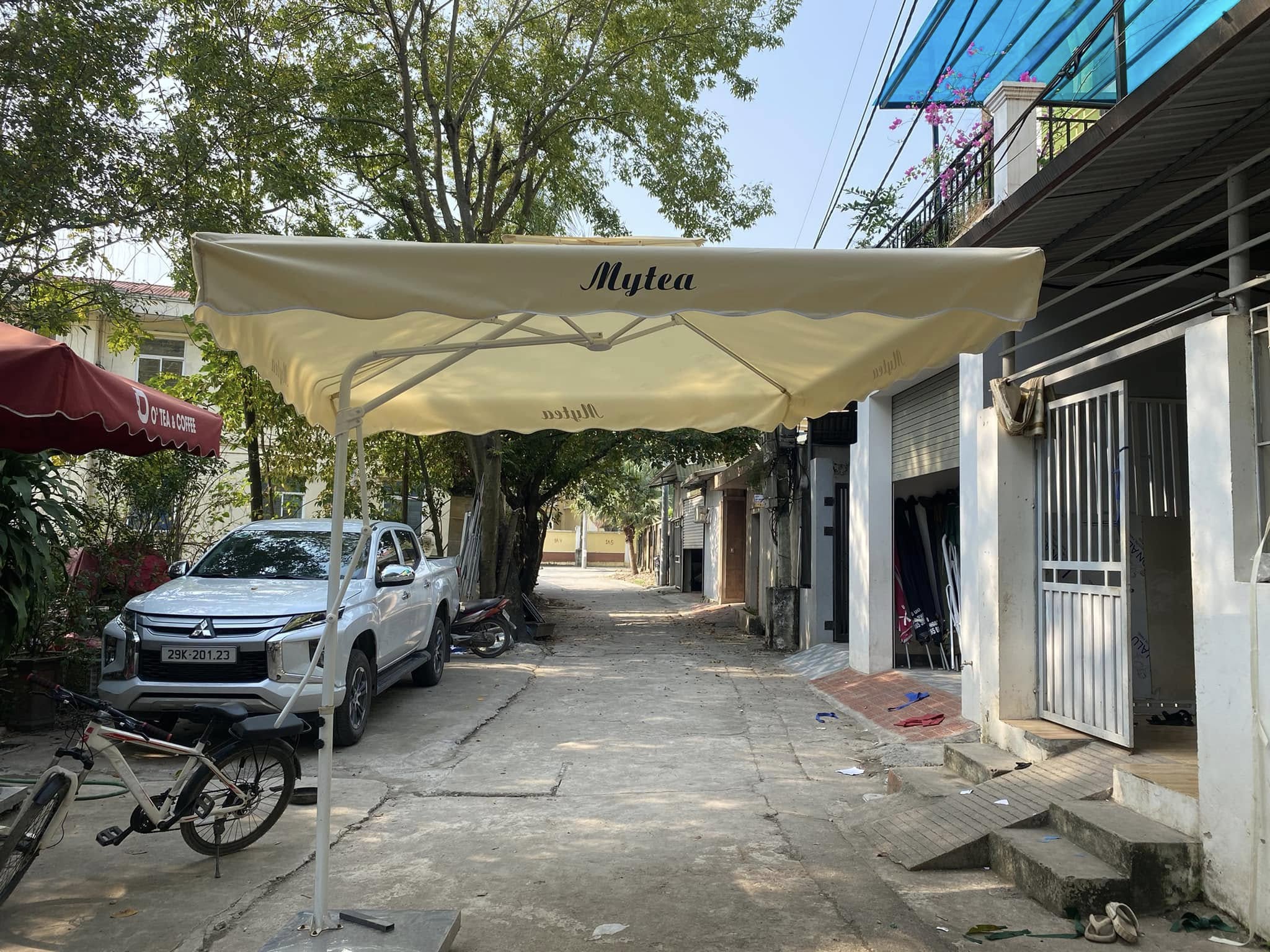 Dù vuông tán kem với kết cấu trụ bên Ô tán vuông màu kem với trụ bên đặt ngoài trời